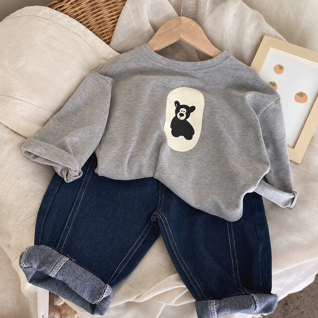 Gray bear-print sweater styled with dark blue jeans