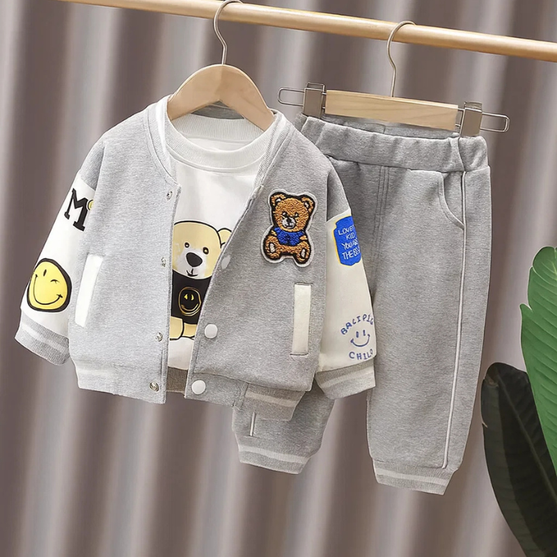 Gray-and-white bear-patch varsity jacket, graphic T-shirt, and matching gray pants