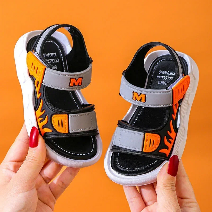 Gray and black sandals with orange flame graphics and strap accents