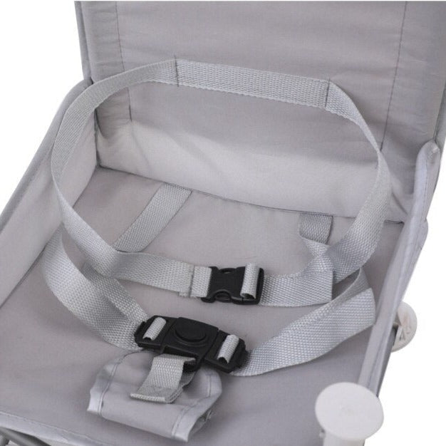 Gray chair seat with harness straps and black buckles