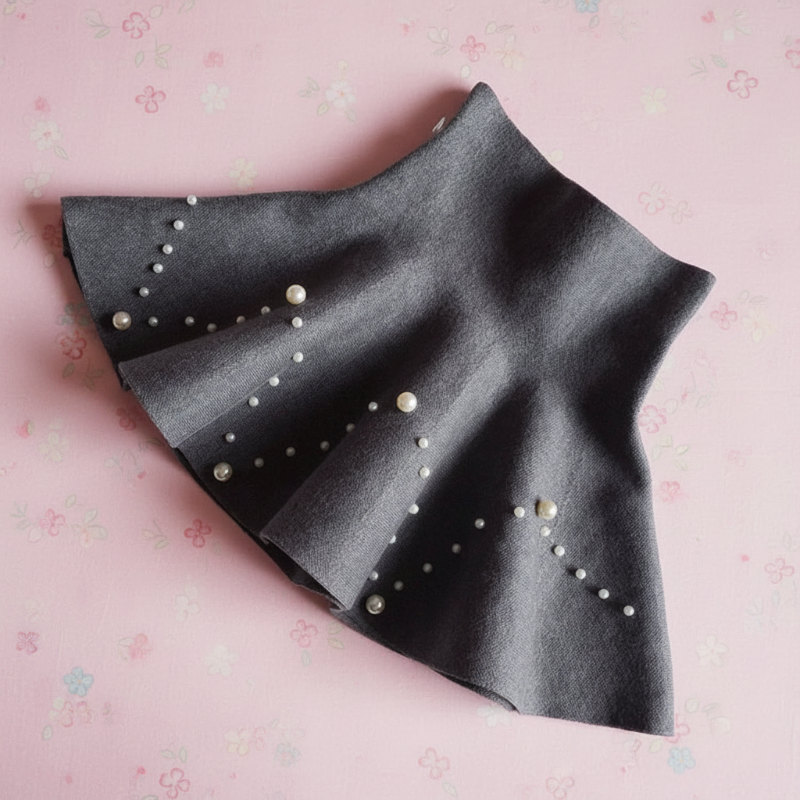 Gray knit skirt laid diagonally with chevron patterns of pearl-style beads