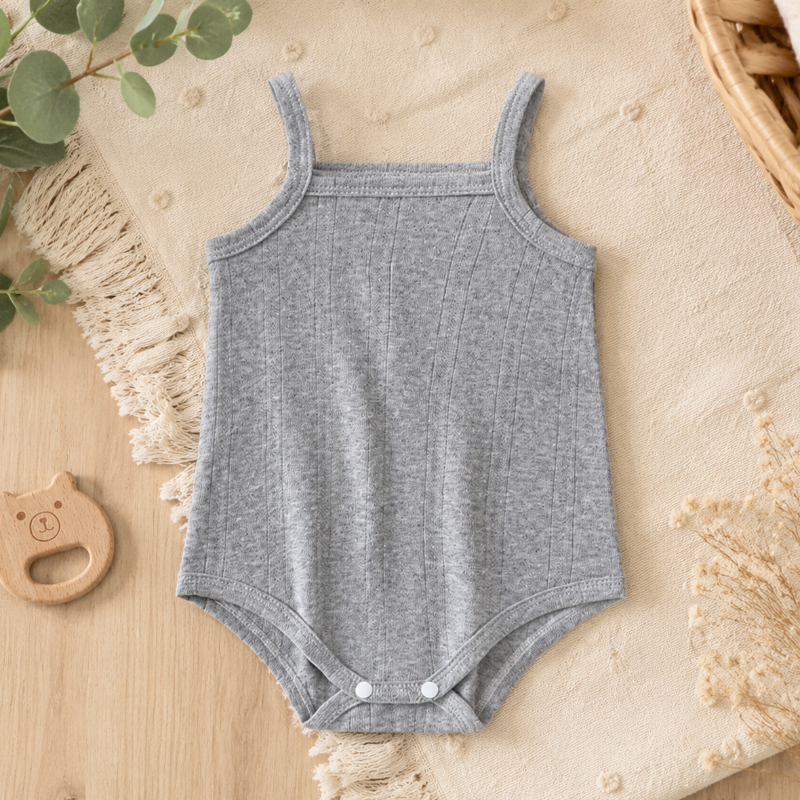 Gray cotton baby bodysuit with thin straps and white bottom snaps