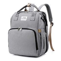 Gray diaper backpack with front zip pocket, top handles and shoulder straps