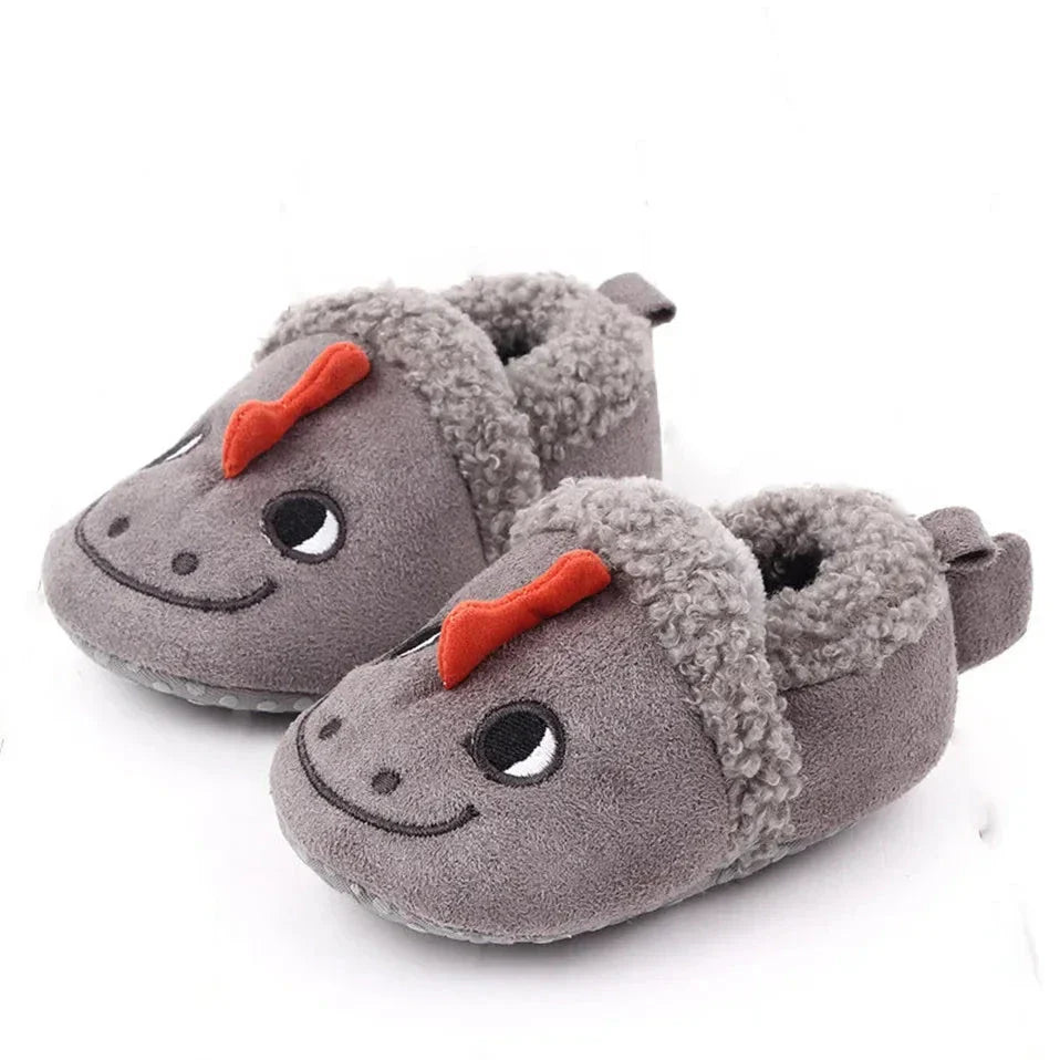 Gray dragon baby slippers with red crests, smiling faces, and fuzzy cuffs.