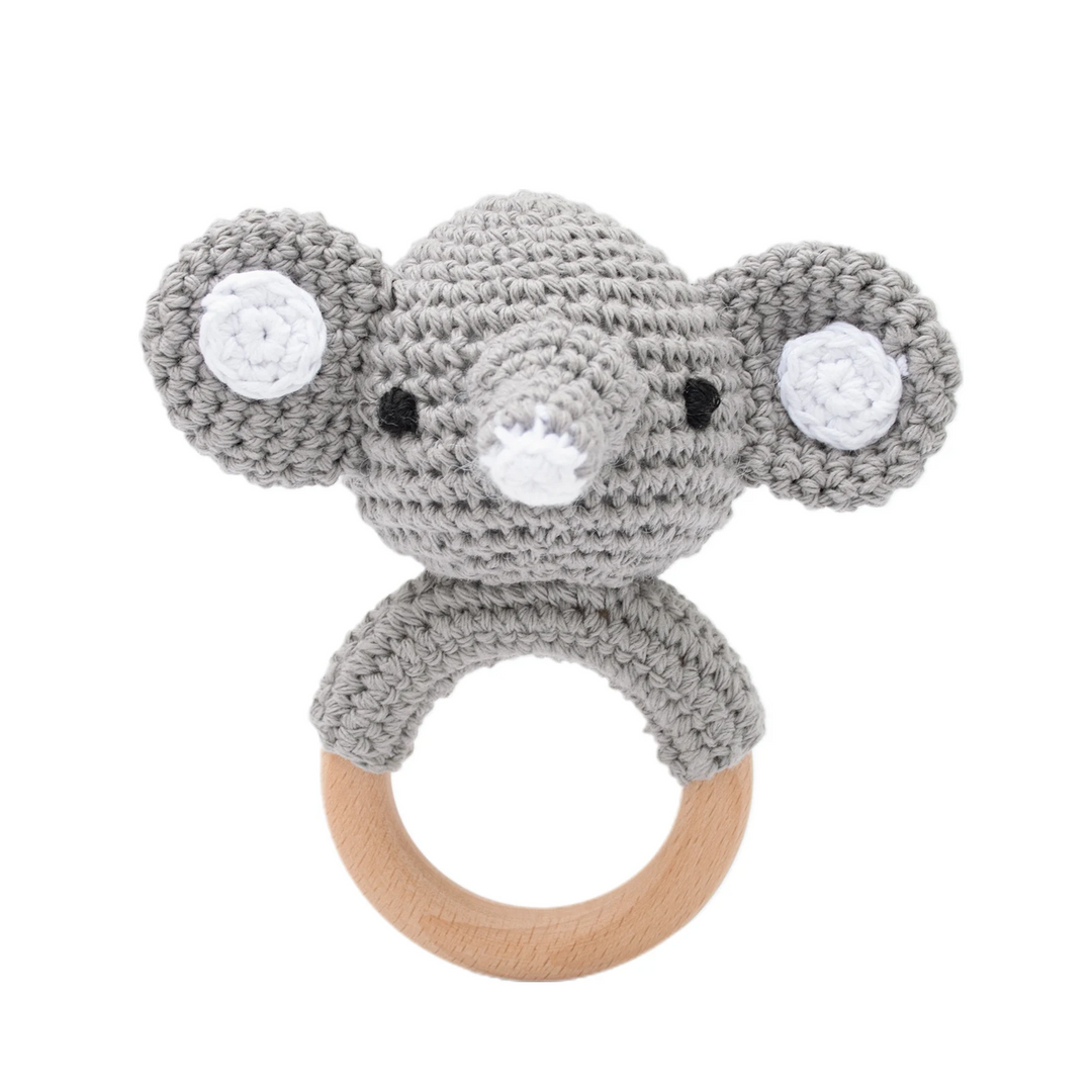 Gray crocheted elephant rattle with wide ears, pink cheeks, and a wooden ring