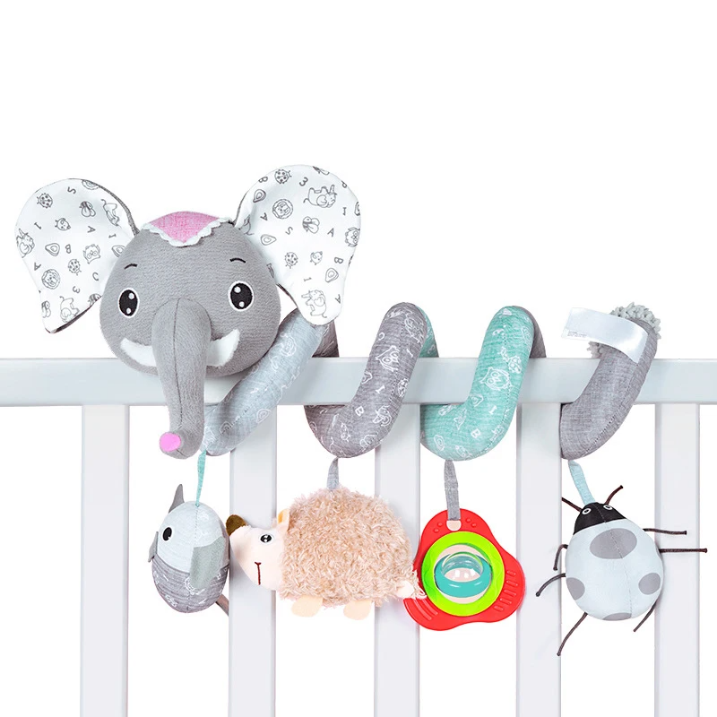 Gray elephant spiral toy on a crib rail with pastel coils and four hanging shapes.