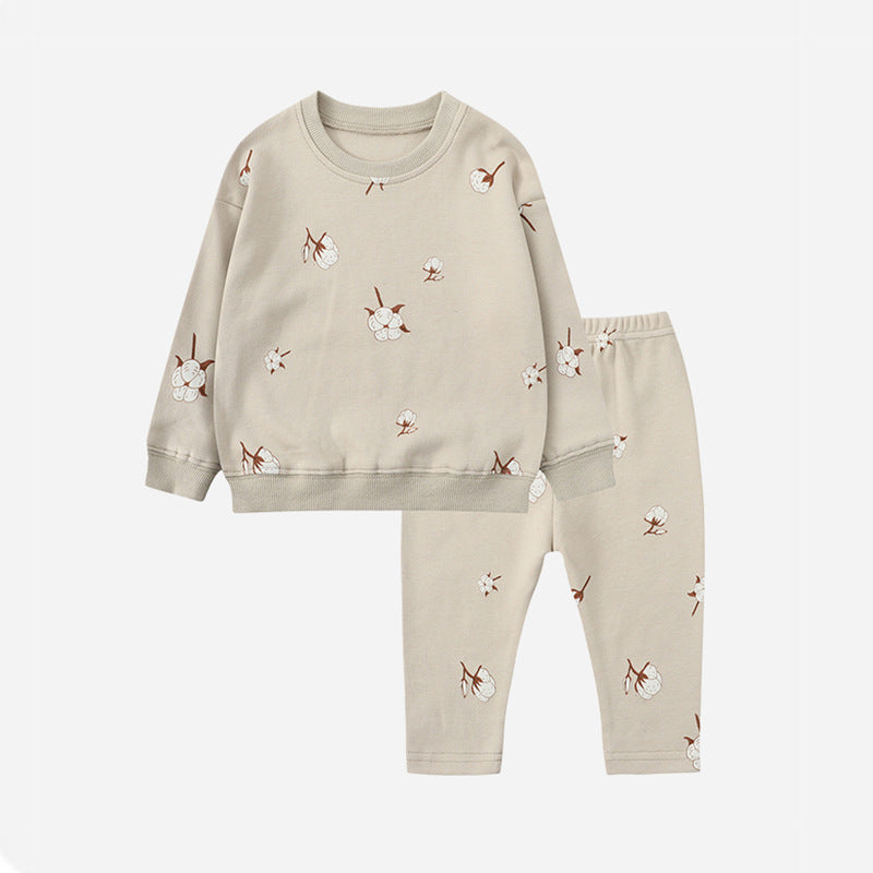 Gray pajama set with a small floral print, long-sleeve sweater, and matching pants.