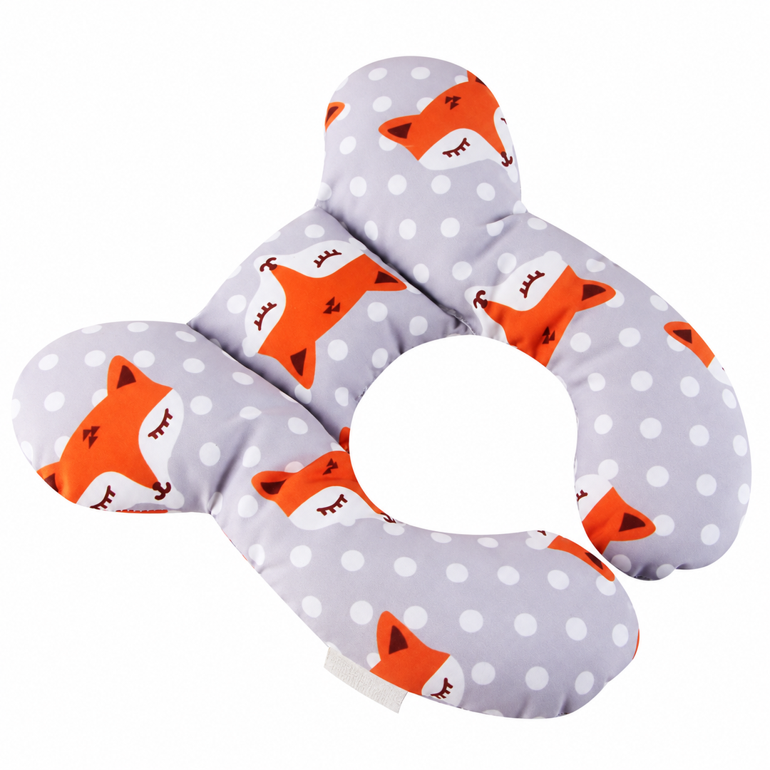 Angled view of a gray butterfly-shaped pillow with orange foxes and white polka dots