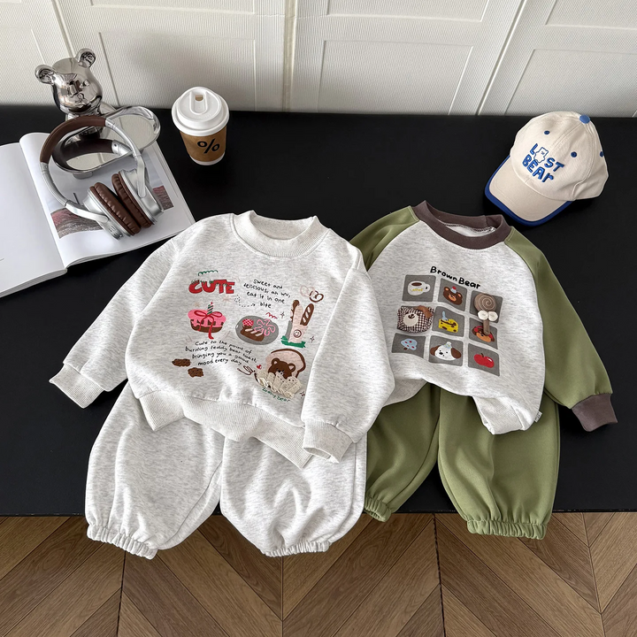 Gray illustrated and green bear-print sweatshirt and pants sets laid side by side