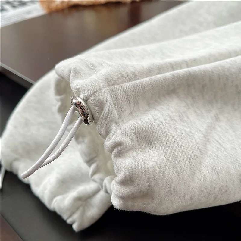 Gray jogger ankle cuff with a drawcord and toggle
