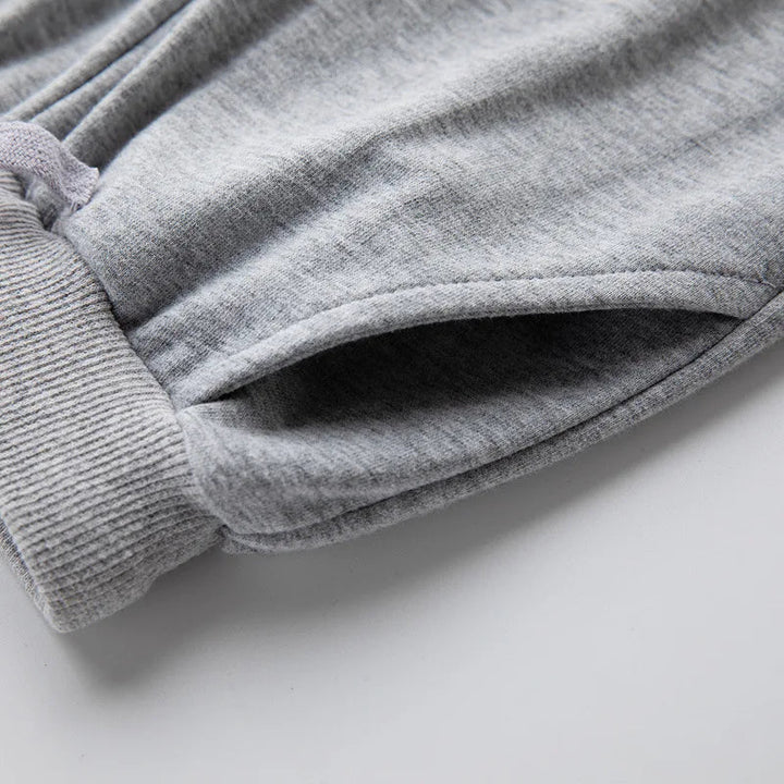 Close-up of gray jogger fabric and ribbed trim