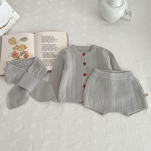 Gray textured knit cardigan and shorts arranged beside a matching scarf