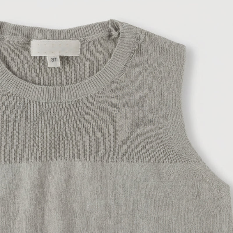 Gray sleeveless knit top showing its round neckline and textured yoke