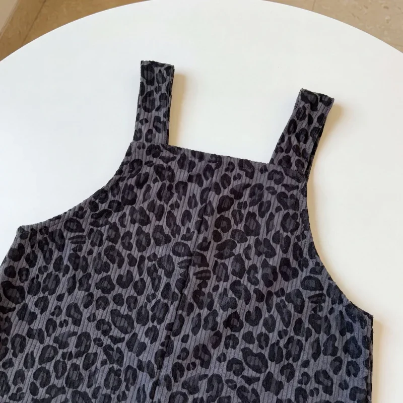 Gray leopard print overall bib and shoulder straps shown close up