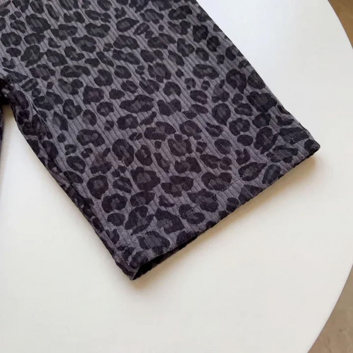 Close-up of the gray leopard print fabric and stitched leg hem