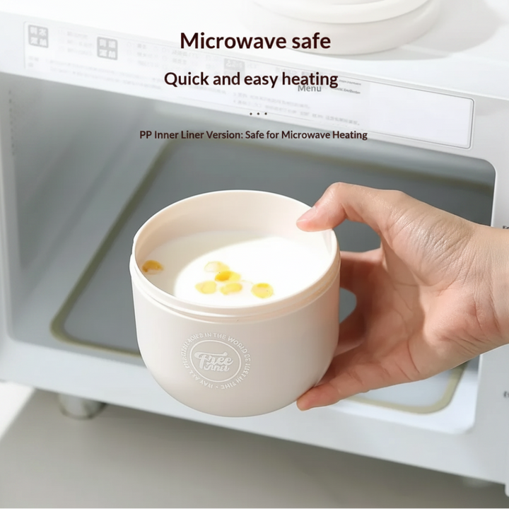 Open gray lunch bowl held at the door of a microwave.
