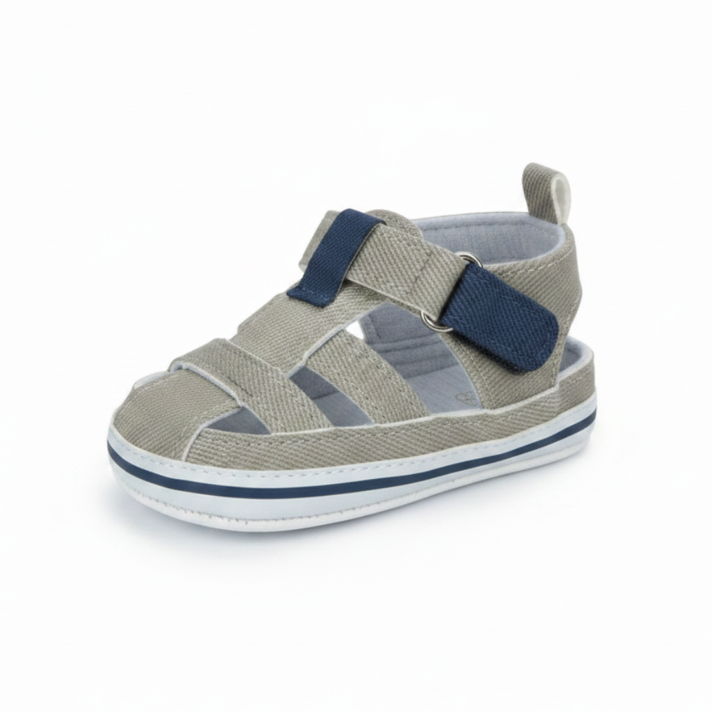 Gray baby sandal with navy strap accents and a white sole