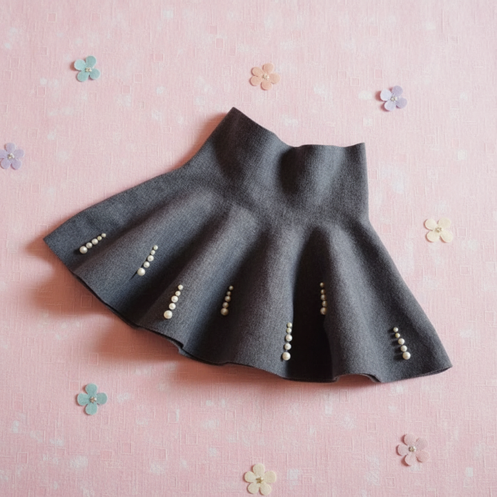 Gray A-line knit skirt with vertical bead rows along the flared hem