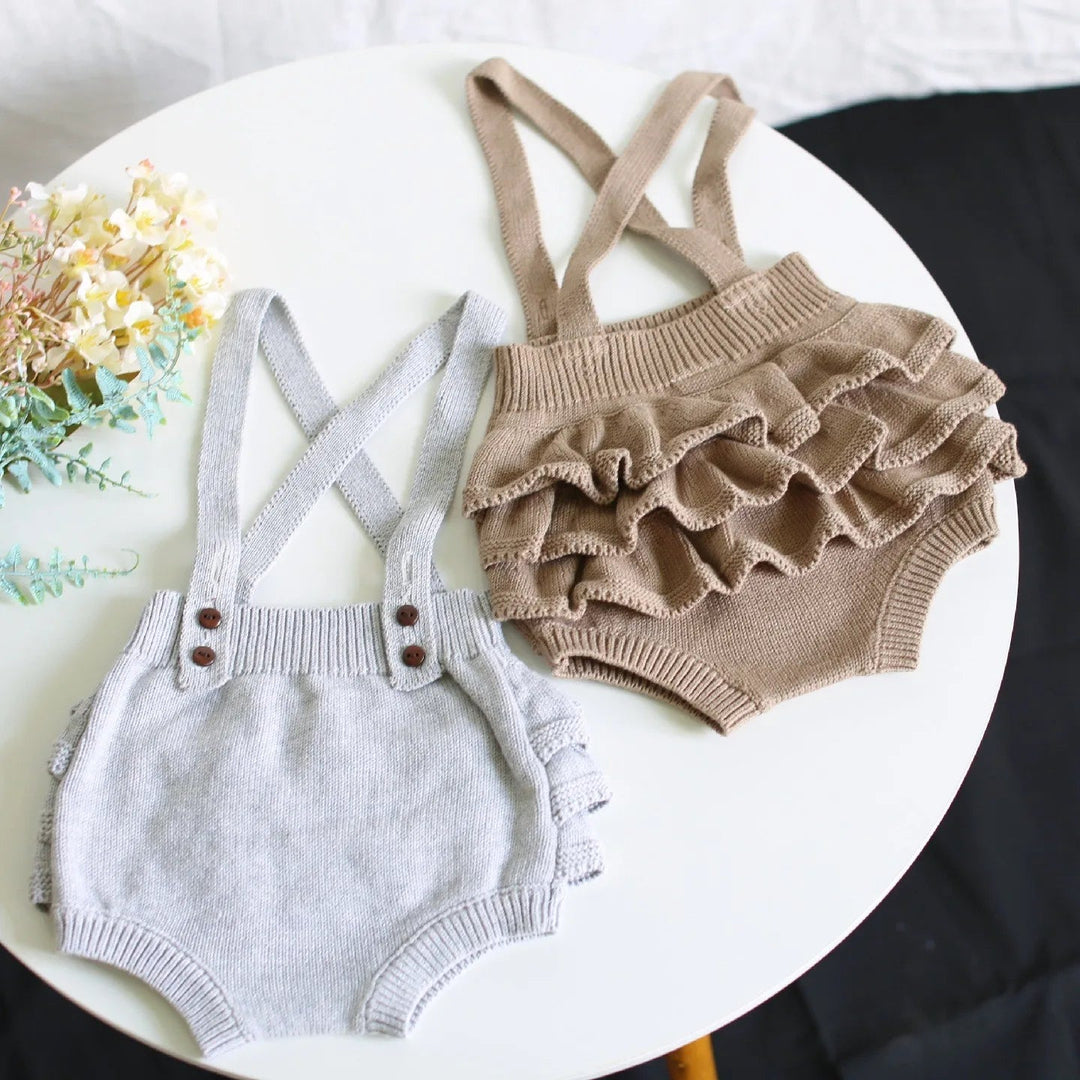 Gray knit romper beside a taupe romper showing its layered ruffle back