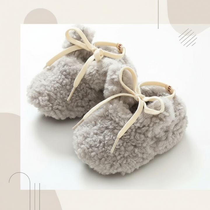 Gray plush baby shoes with cream bow-tied laces