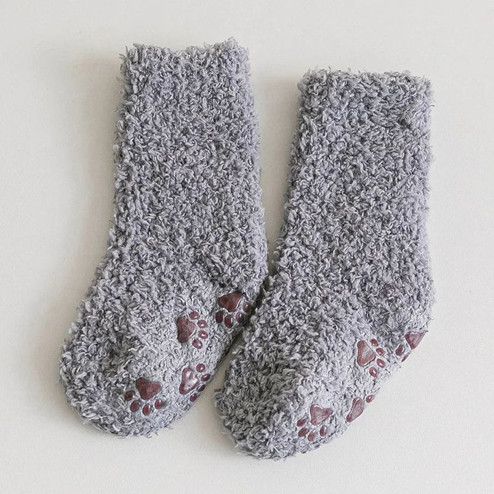 Pair of gray fleece socks with paw-print details visible on the bottoms.