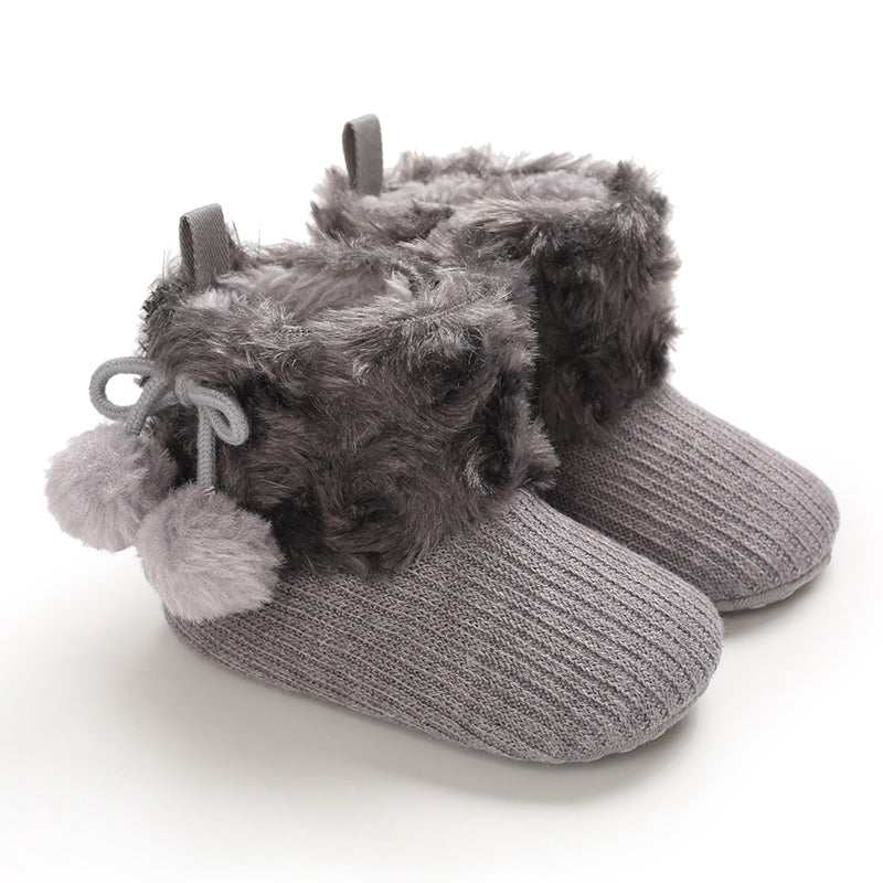 Gray baby boots with fluffy cuffs and tied pom-pom accents