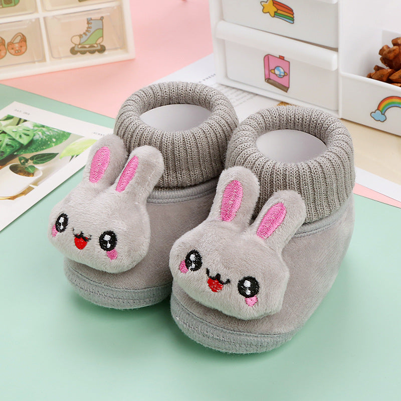 Gray rabbit baby slippers with pink ear details and knitted ankle collars