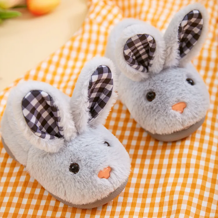 Pair of gray plush rabbit slippers with black-and-white checkered ear panels