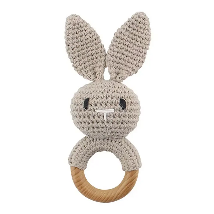 Gray crocheted rabbit rattle with upright ears and a wooden ring