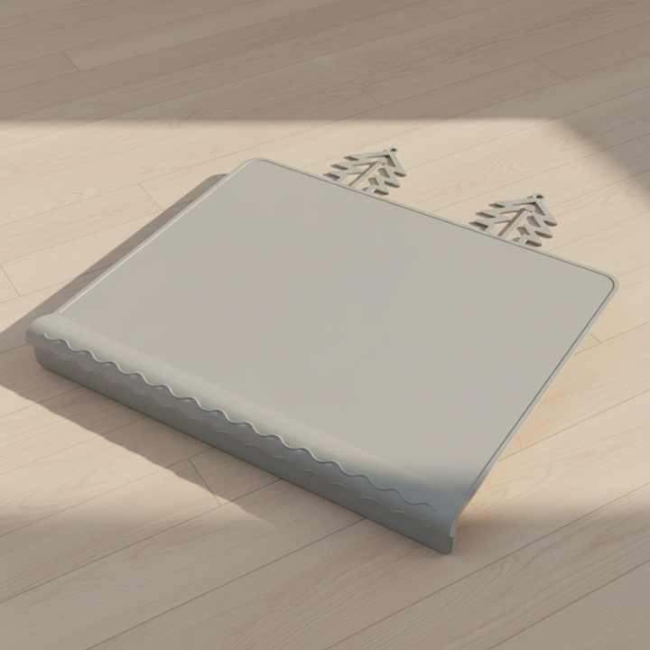 Gray silicone placemat with raised edging and two tree-shaped tabs