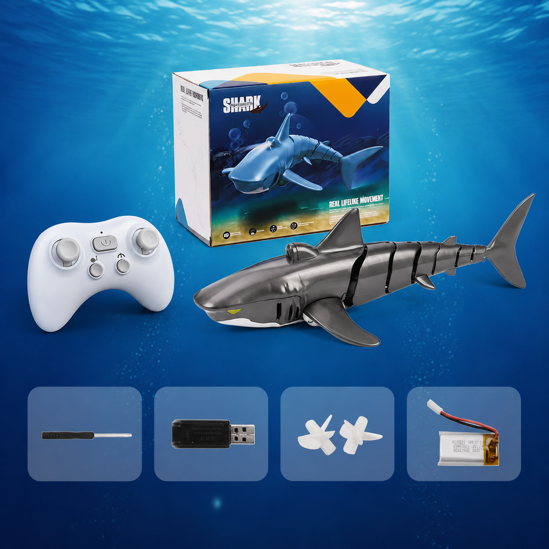 Gray RC shark with a white controller, retail box and charging accessories