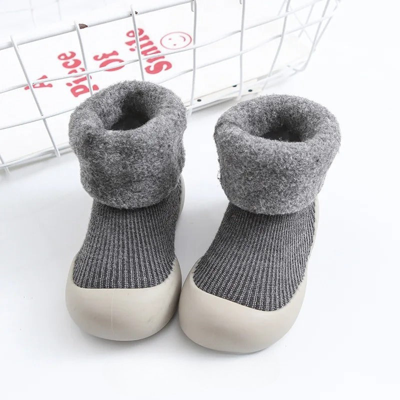 Gray ribbed baby socks with plush folded cuffs and light-colored soles