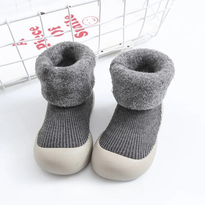 Gray ribbed baby socks with plush folded cuffs and light-colored soles