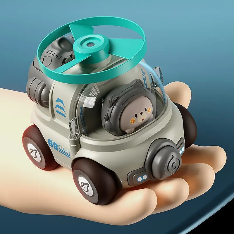 Gray toy car with a green rotor and clear cabin resting on an open palm