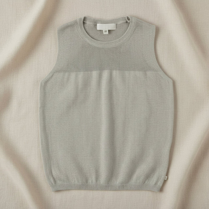 Gray sleeveless knit top with a textured yoke and ribbed hem