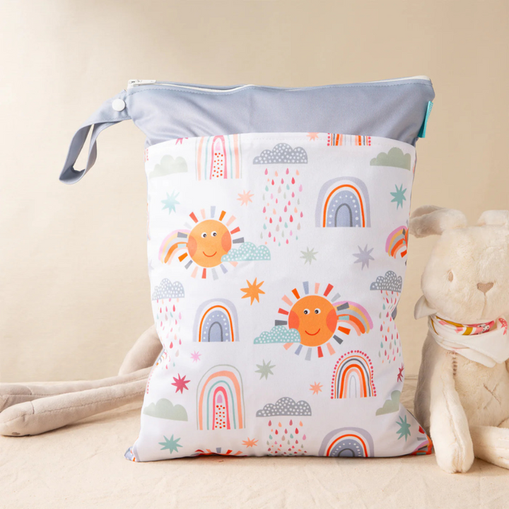 Gray-trim diaper wet bag with smiling suns, rainbows, clouds, and a snap loop