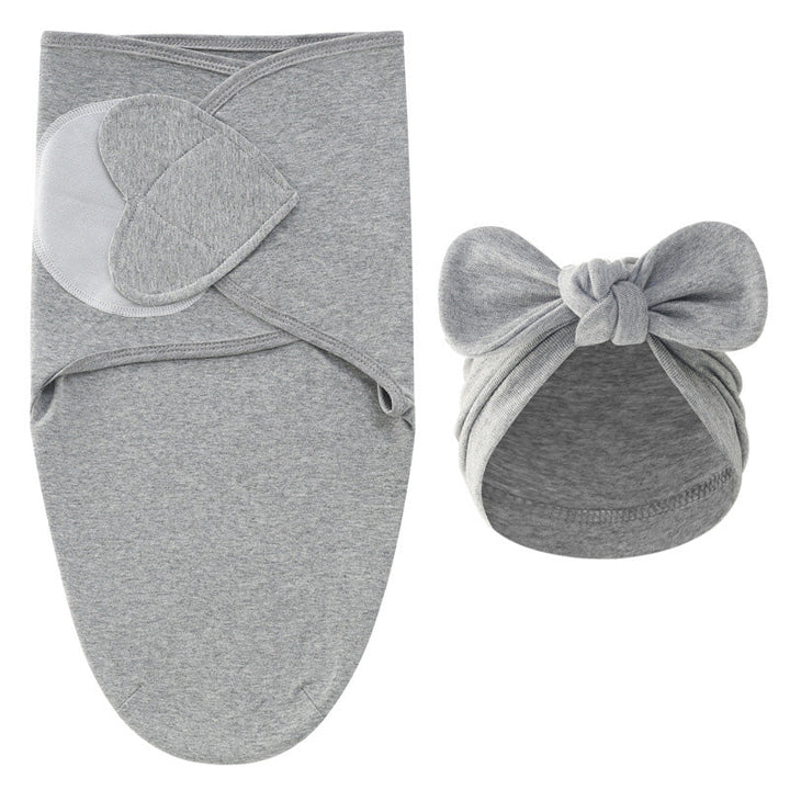 Gray swaddle blanket with overlapping panels and a matching gray bow hat
