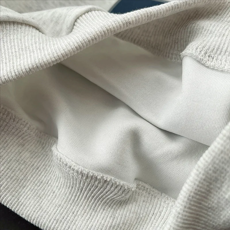 Close-up of the gray sweatshirt hem and smooth inner fabric