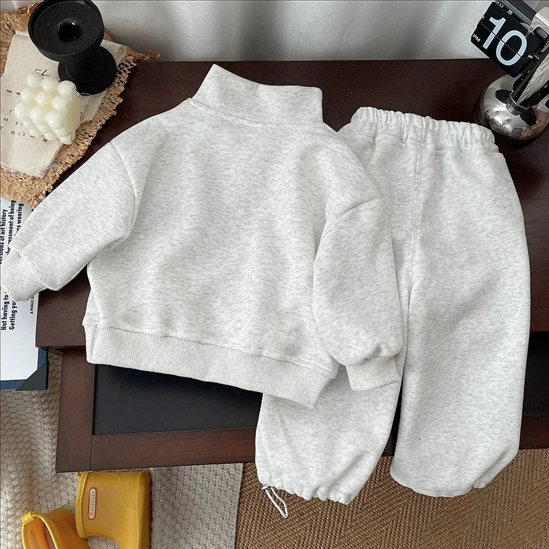 Back view of the gray sweatshirt and matching joggers laid flat