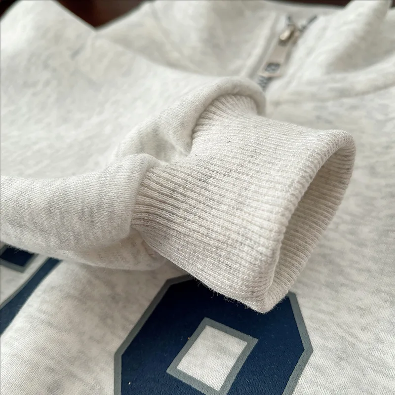 Gray sweatshirt sleeve showing its ribbed cuff