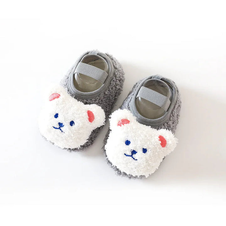 Pair of gray baby slippers with white bear faces and elastic bands