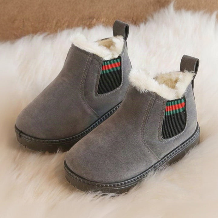 Gray plush-lined winter boots viewed from the front and side on a white rug.