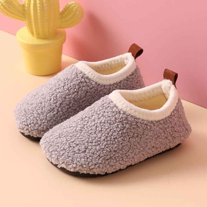Gray wool slippers with cream-colored lining, brown heel pull tabs, and black soles