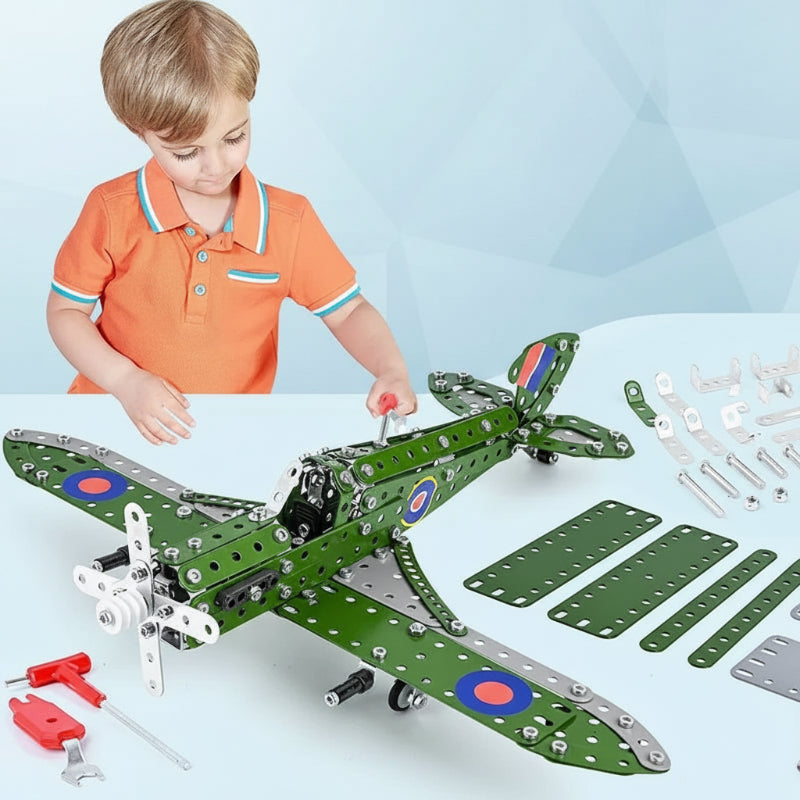 A child building a green airplane model with metal pieces, fasteners, and hand tools