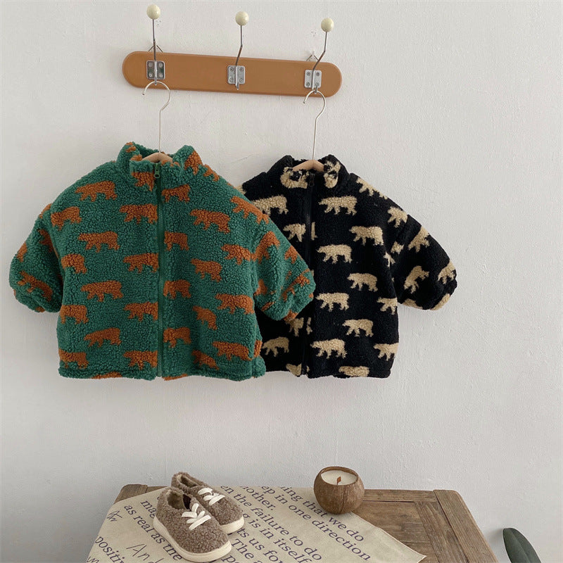 Green and black bear-print fleece jackets displayed side by side on wall hooks