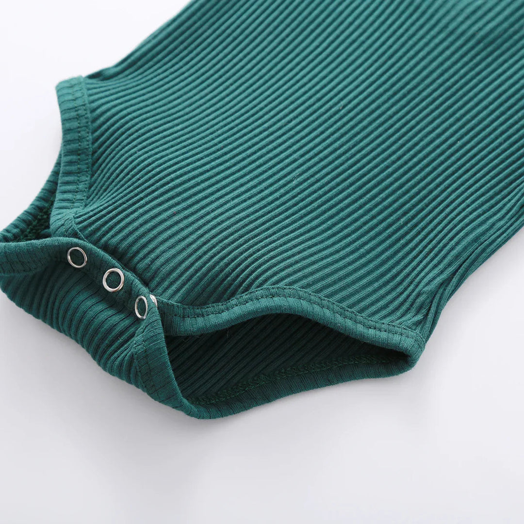 Green ribbed baby bodysuit showing the three bottom snap fasteners
