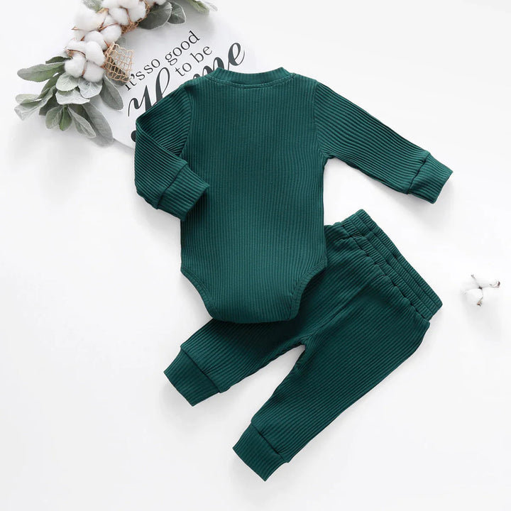 Back view of a green long-sleeve baby bodysuit with matching ribbed pants