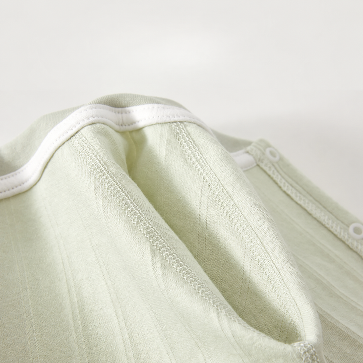 Inside neckline and finished seams of the green cotton baby romper