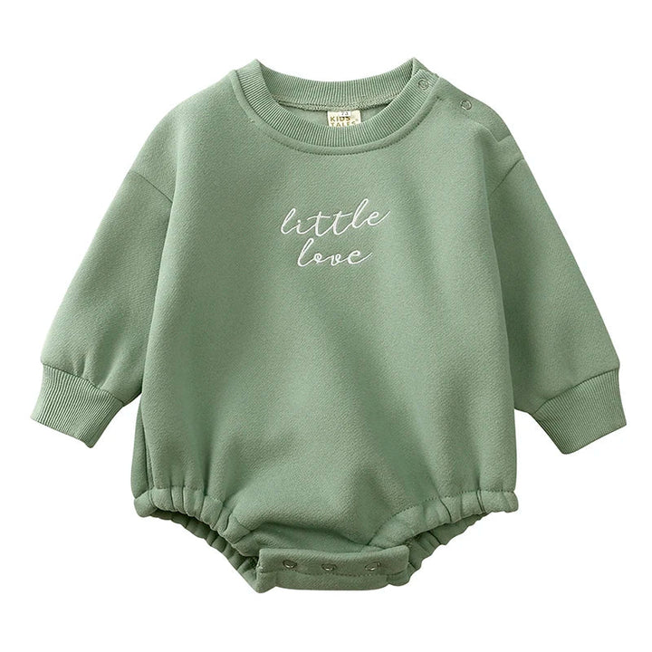 Green long-sleeve baby romper with embroidered lettering, ribbed cuffs, and crotch snaps