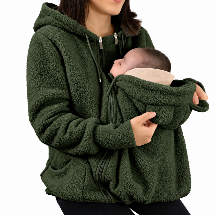 Green babywearing jacket modeled with a baby held close at the front